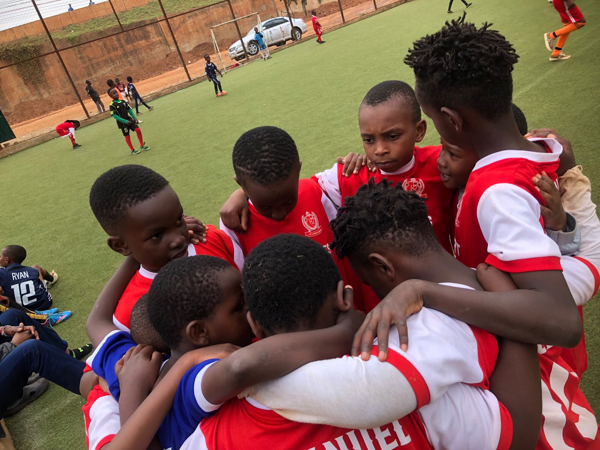 Academy players huddled together on the pitch before kick-off